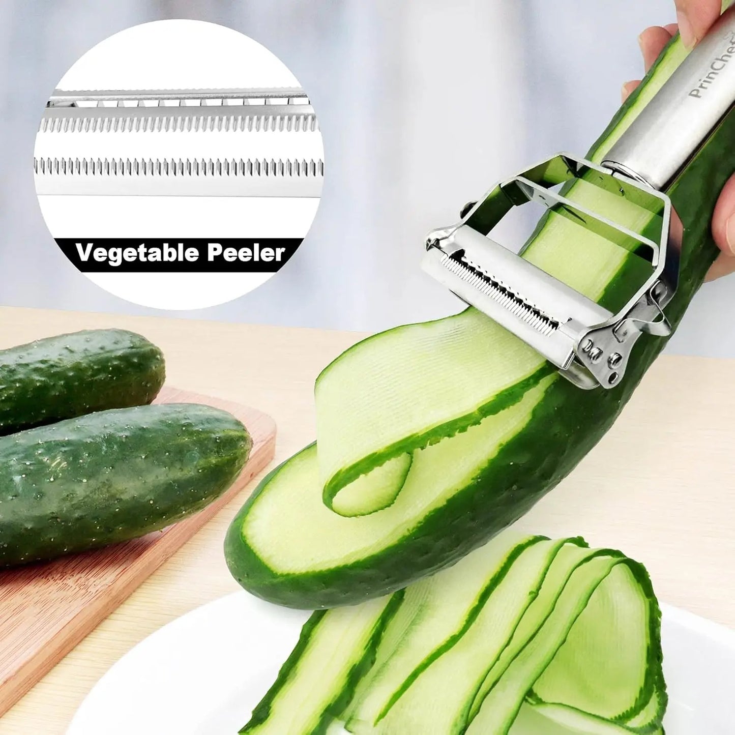 Stainless steel vegetable peeler tool being used to slice a cucumber with close-up of the blade in a kitchen