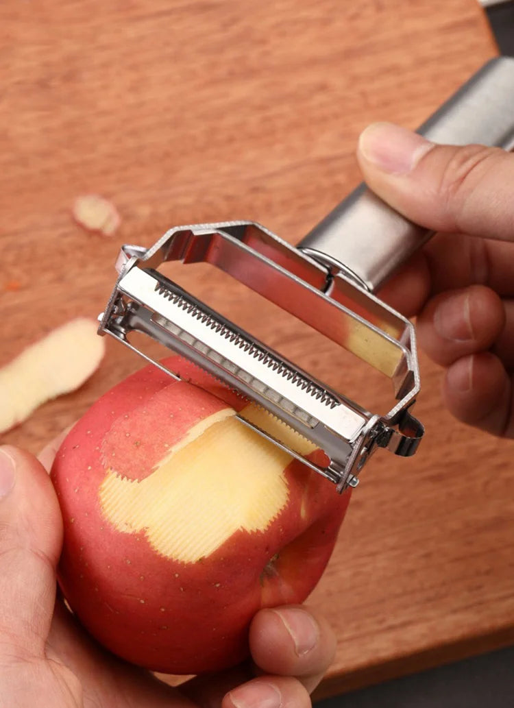 Person peeling an apple with a metal fruit vegetable peeler kitchen knife 